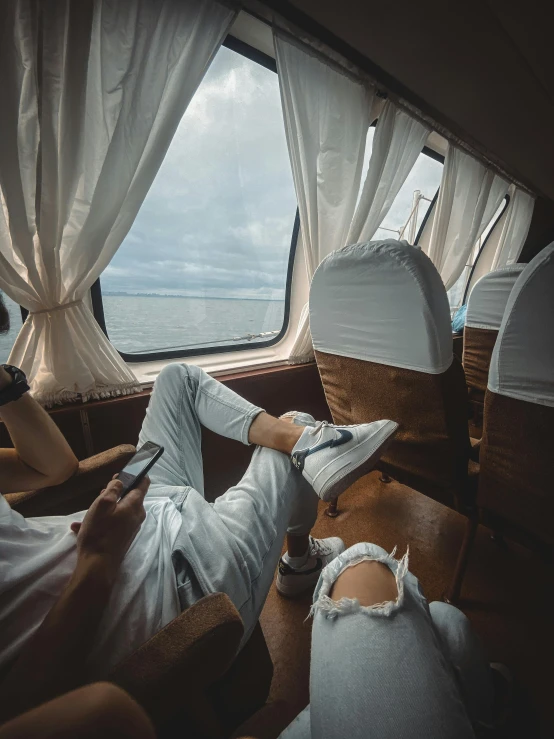 two people in a boat looking out of the windows