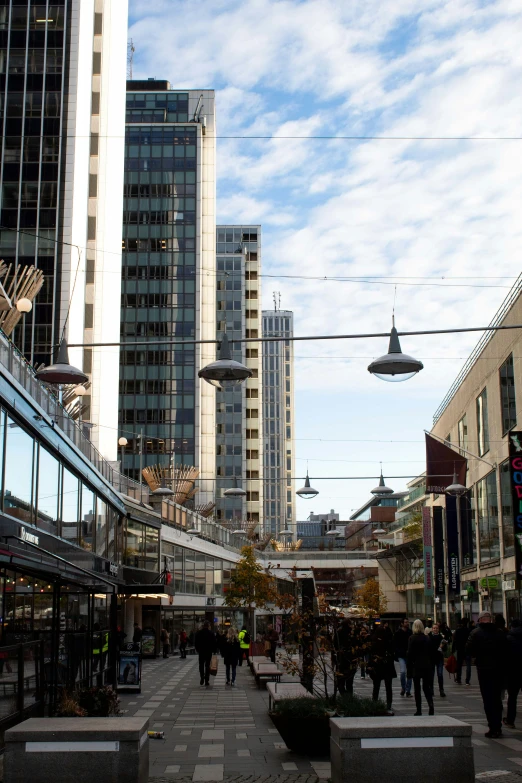 an urban city in the daytime with many people walking around