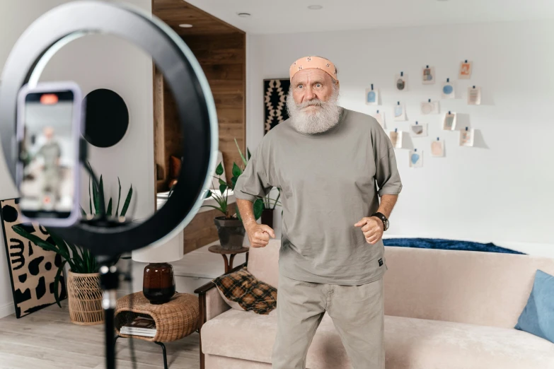 an older man taking a picture of himself in his living room