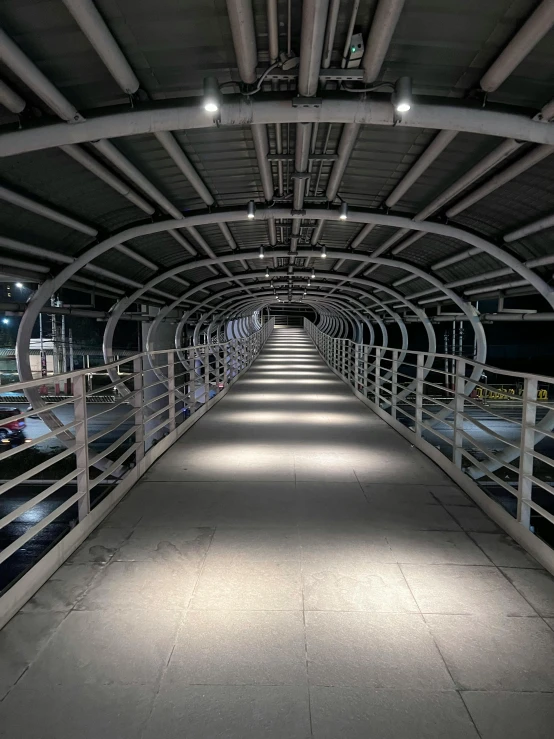 a hallway with steel railings leading to the street