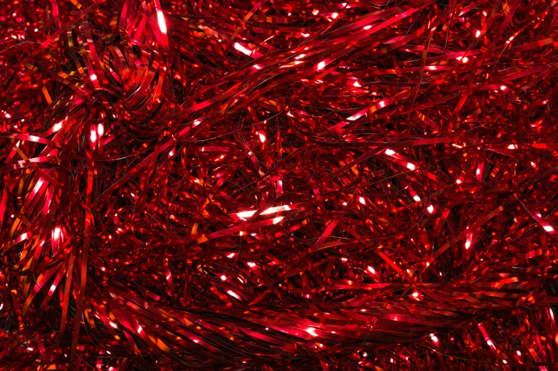 many red pieces of metallic glitter on the surface