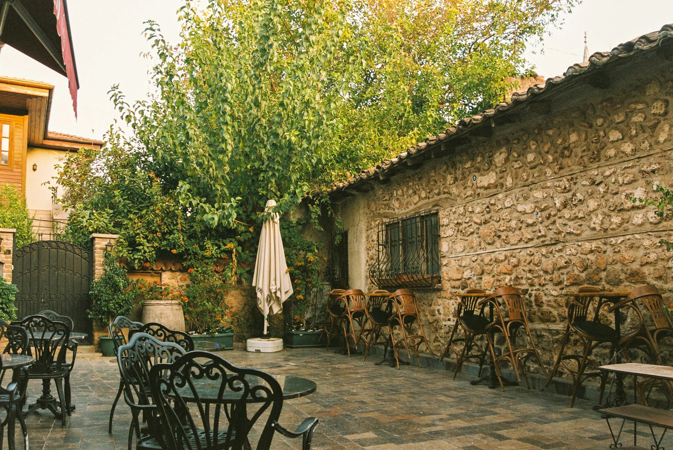 a patio with tables and chairs set outside