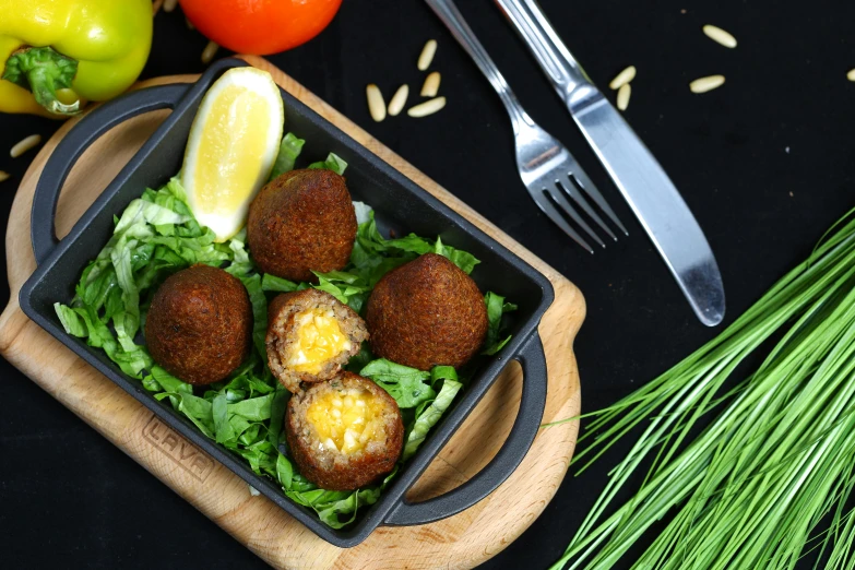 a plate with a meat ball and vegetable salad