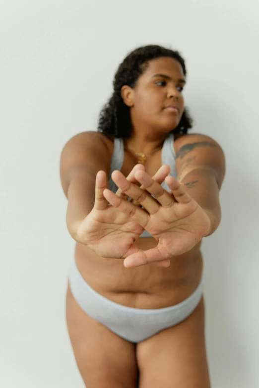 a woman is making a gesture in front of the camera