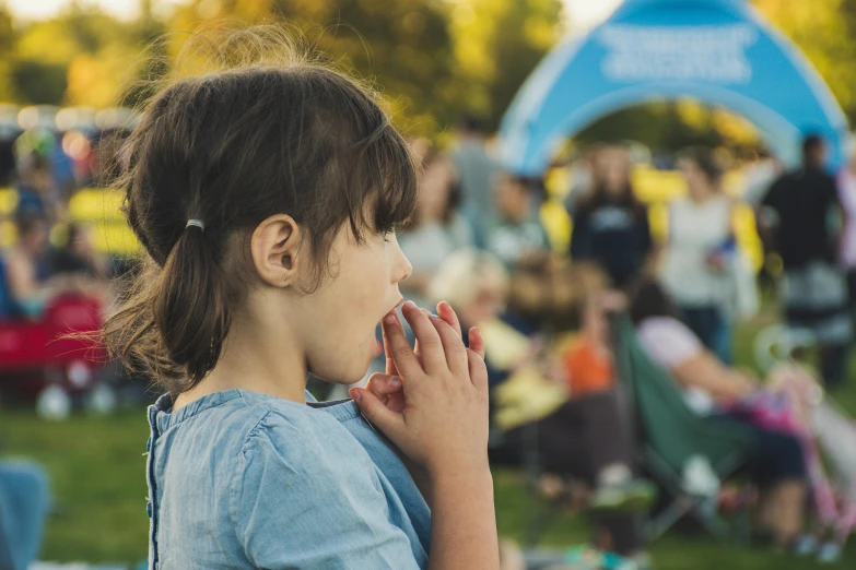 a little girl standing in front of an audience