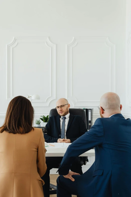 some business men are sitting at the desk talking