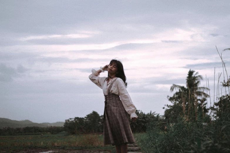 a woman stands on steps in the dirt