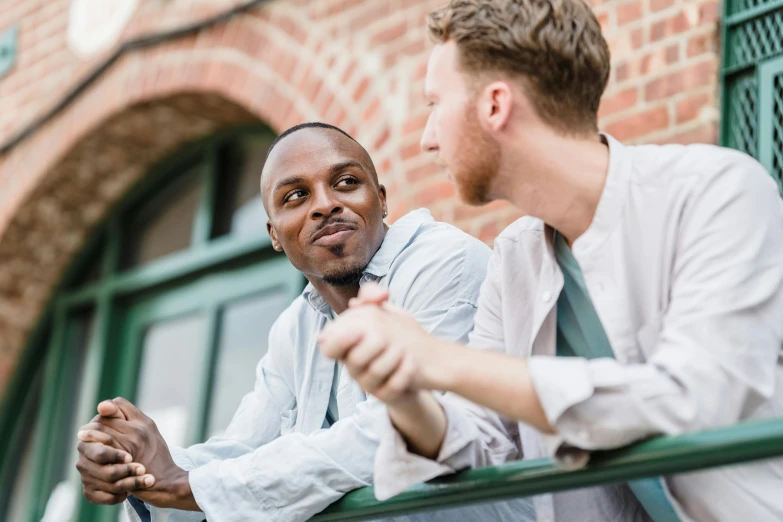 two men are looking out a window outside