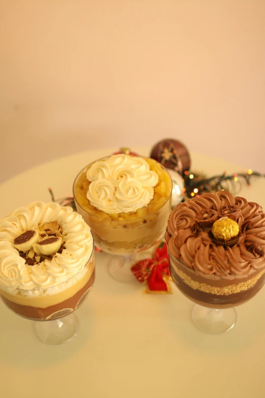 four small desserts on small cake pedestals on a table