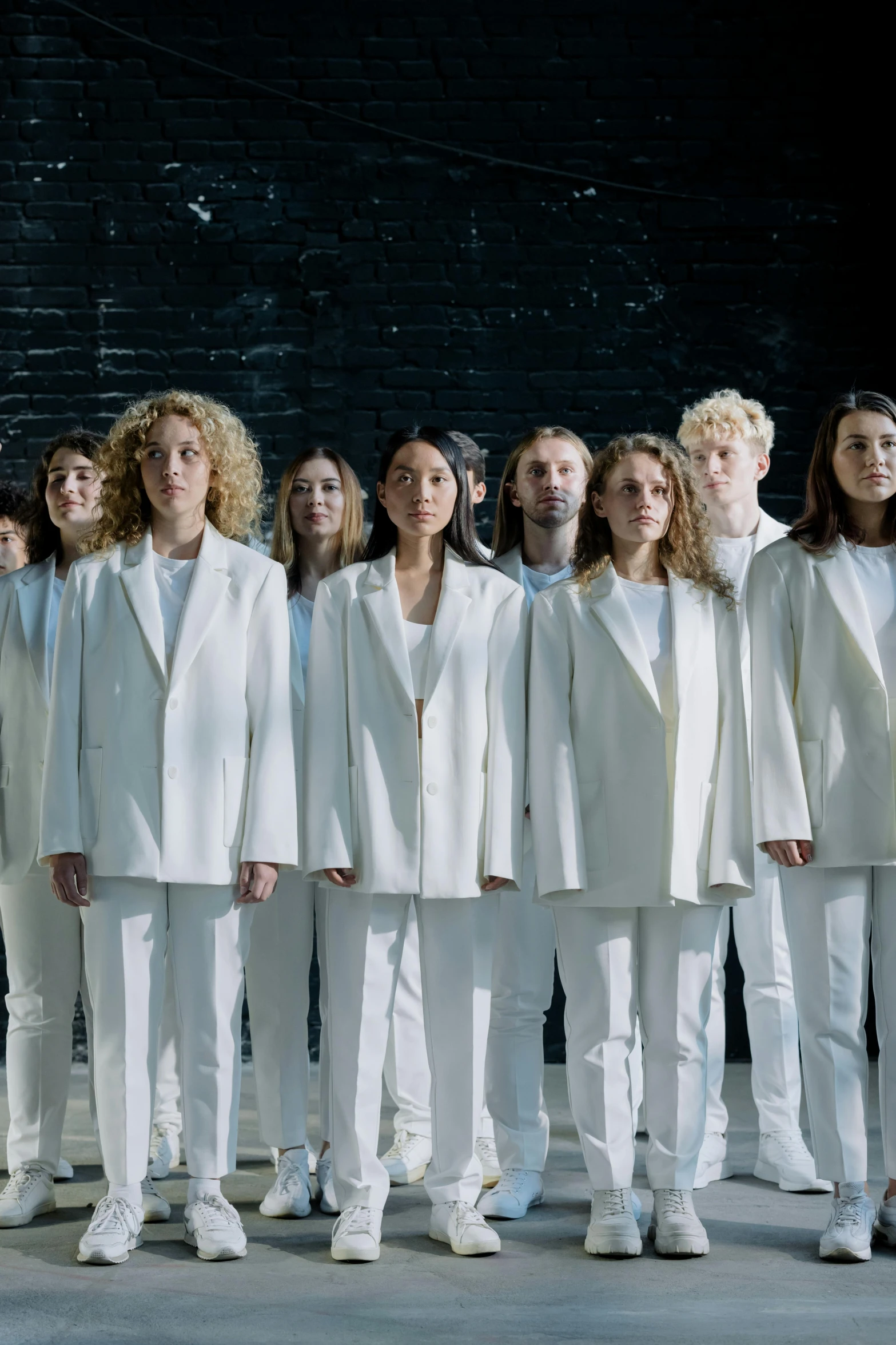 a large group of people wearing white clothing standing together