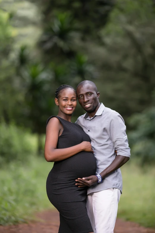 a man standing next to a pregnant woman