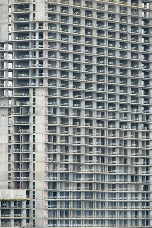 a very tall building next to a body of water