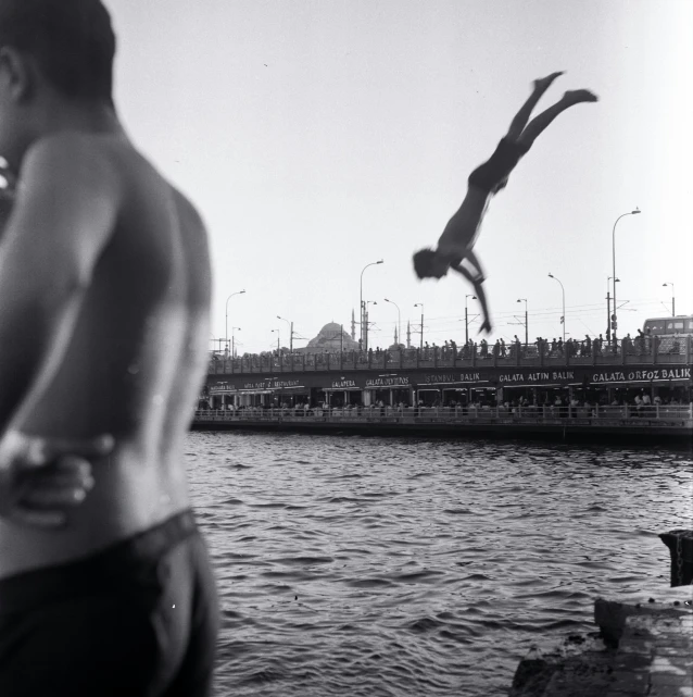 a man with  flying into the air near the ocean