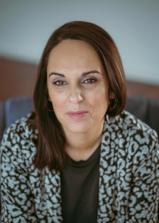 a woman sitting at a table with an untidy look on her face