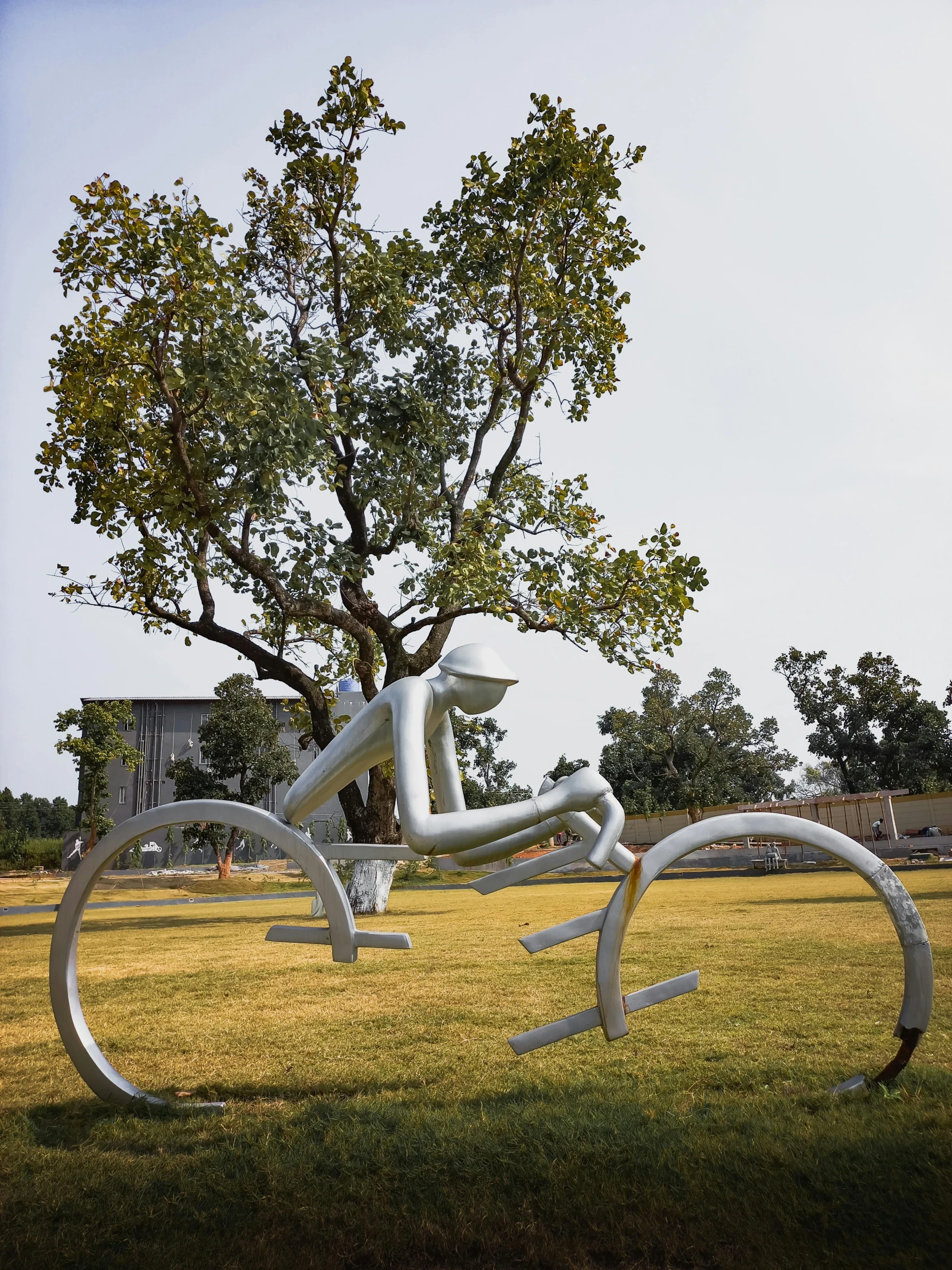 the sculpture has been placed in a grassy area