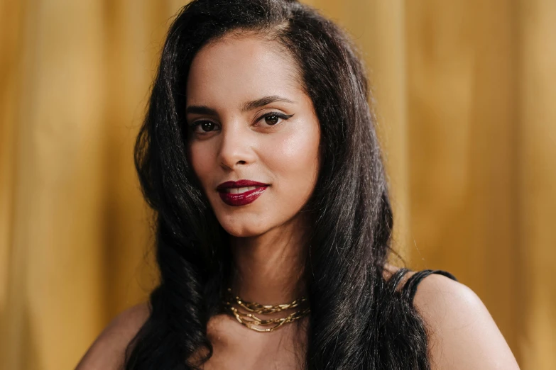 an indian woman with a gold necklace and a red lip