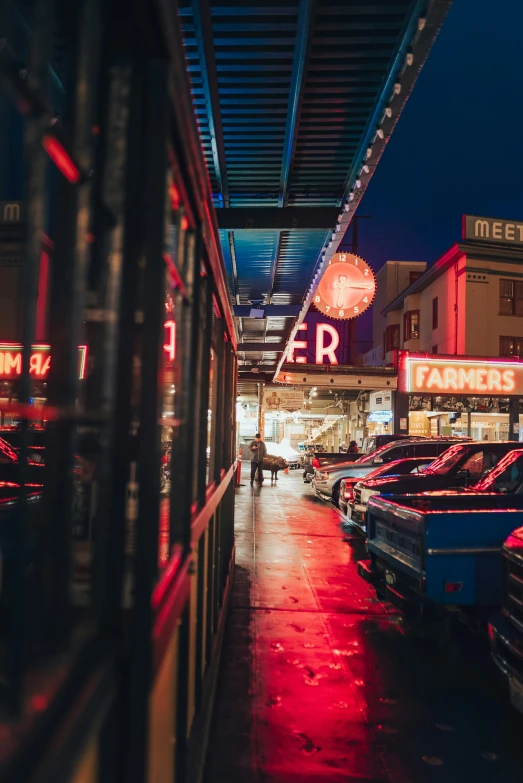 the car dealership at night with cars parked outside