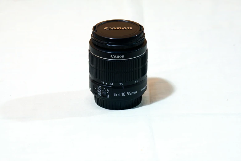 a canon lens is sitting on a table