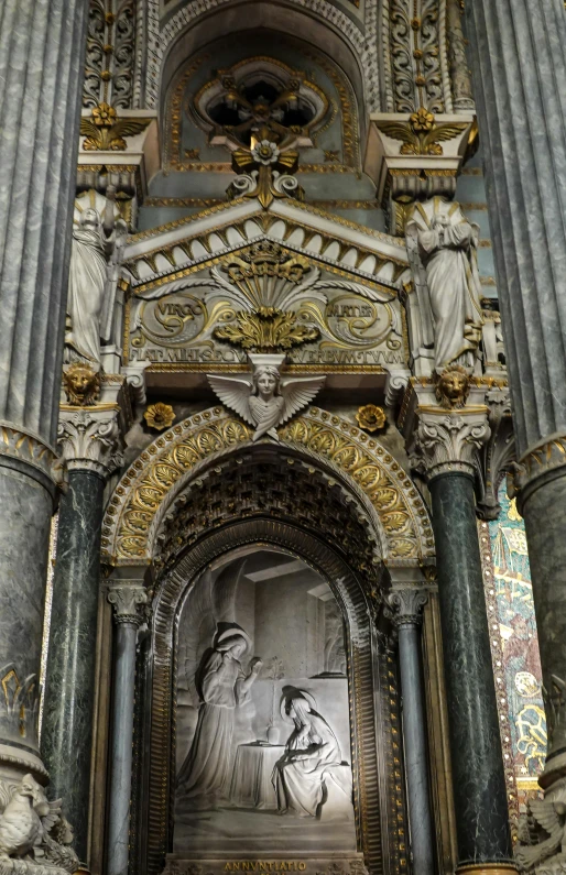 the inside of an ornate gothic cathedral with gold and silver detailing