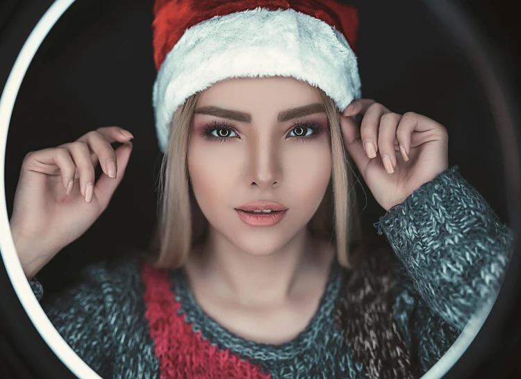 a woman wearing a santa claus hat is posing