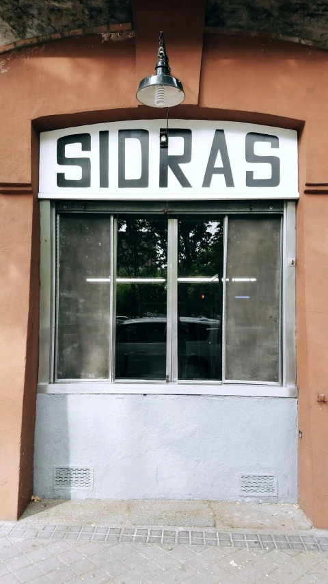 an image of a building window with a sign that reads sidras