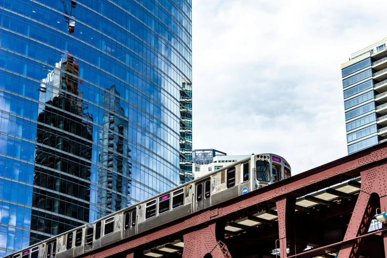a train passing by a bunch of tall buildings