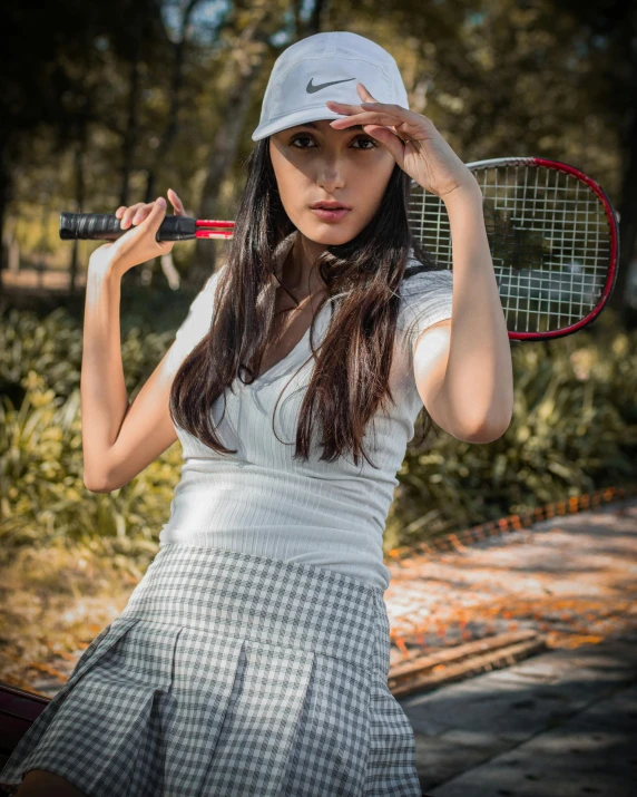 a woman holding a tennis racket while looking at soing