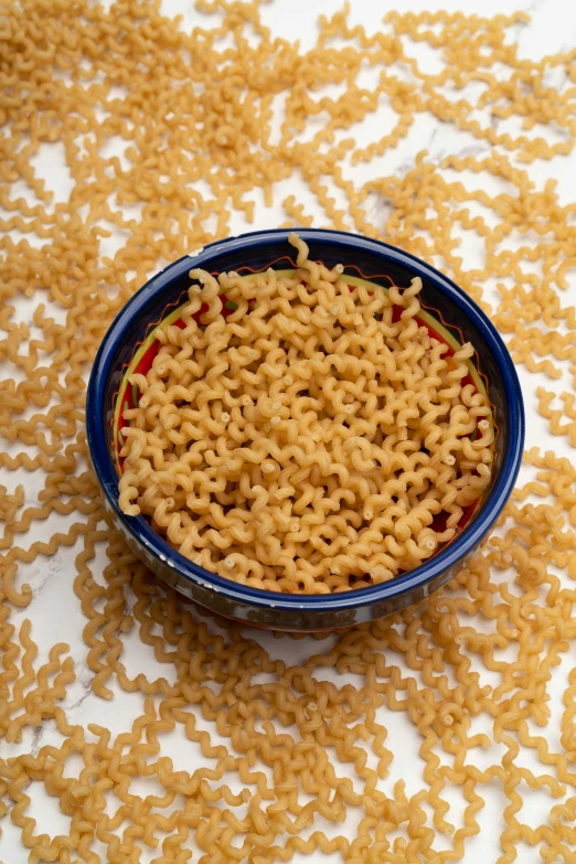 a bowl of cooked food lying on the ground