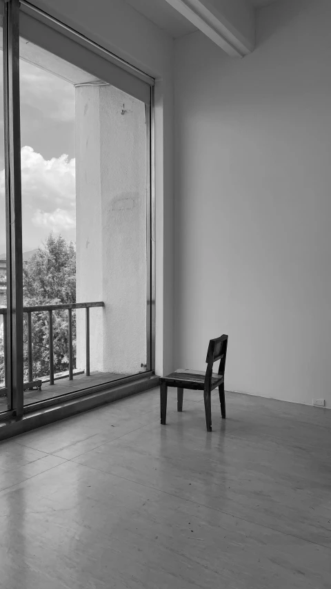 a bench in a large room with a view of trees