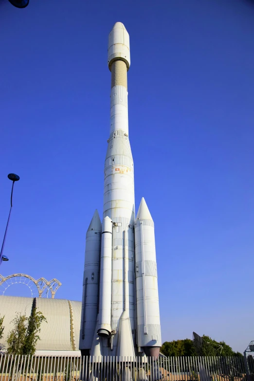 a large white rocket type structure with two rockets on it's side