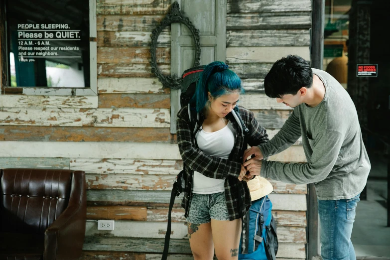 a man and woman standing in front of a building with backpacks