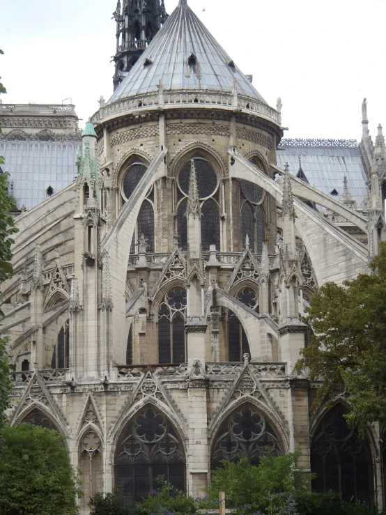 an old cathedral in a city with some people walking around