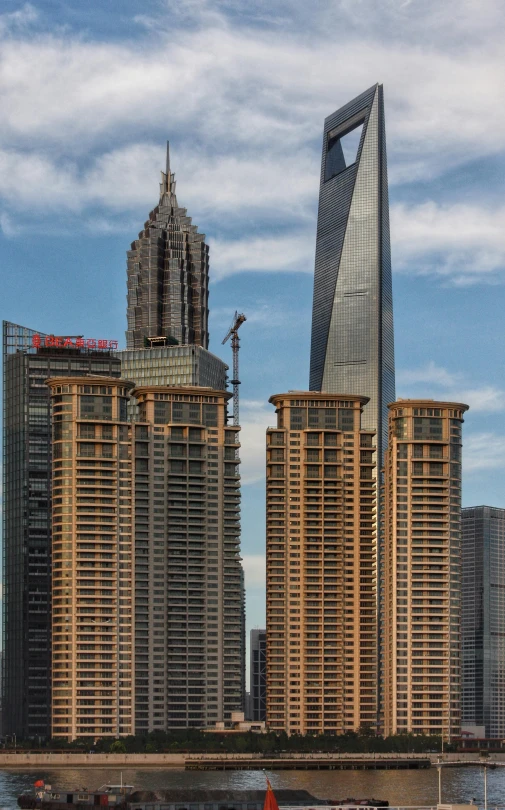 a couple of very tall buildings sitting next to a lake