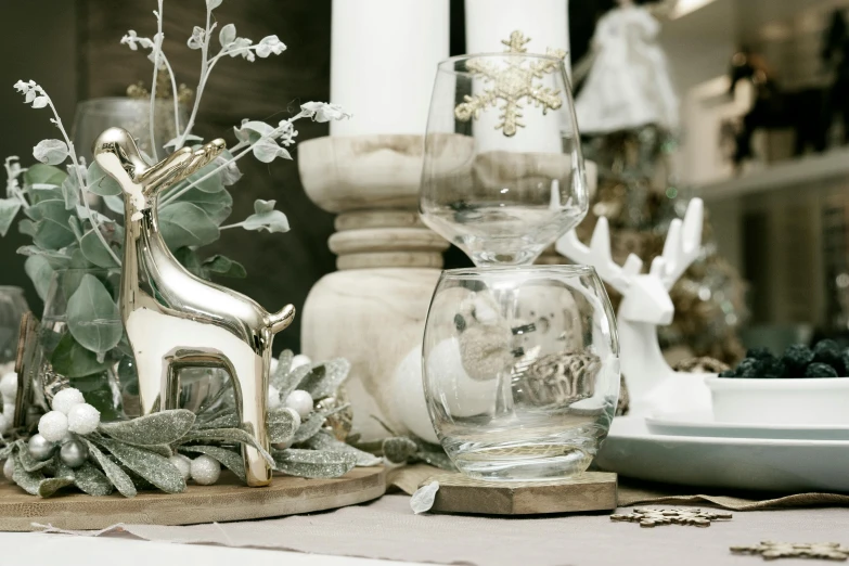 two crystal christmas decorations sit next to a white table