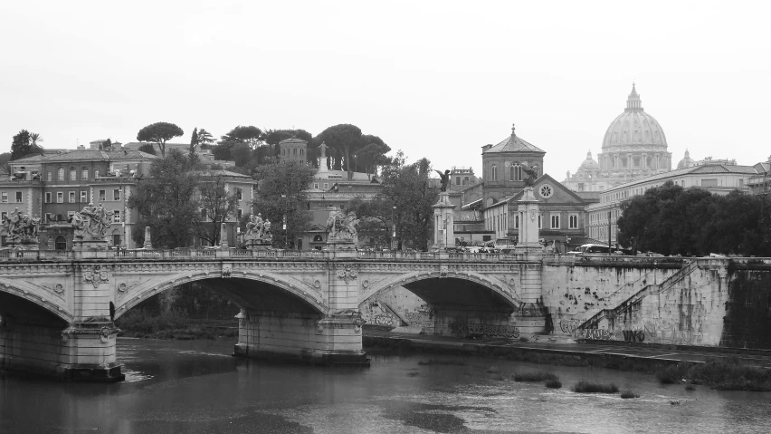 a large river under a bridge with buildings on it