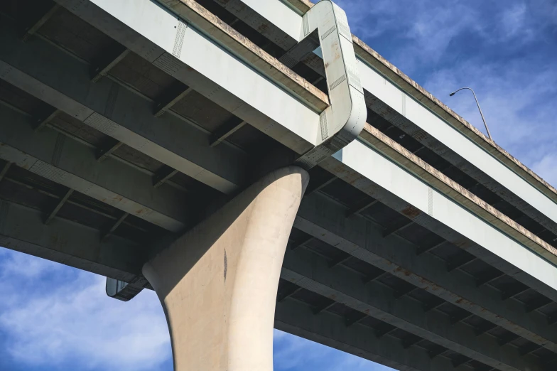 the underside of a bridge with blue sky in the background