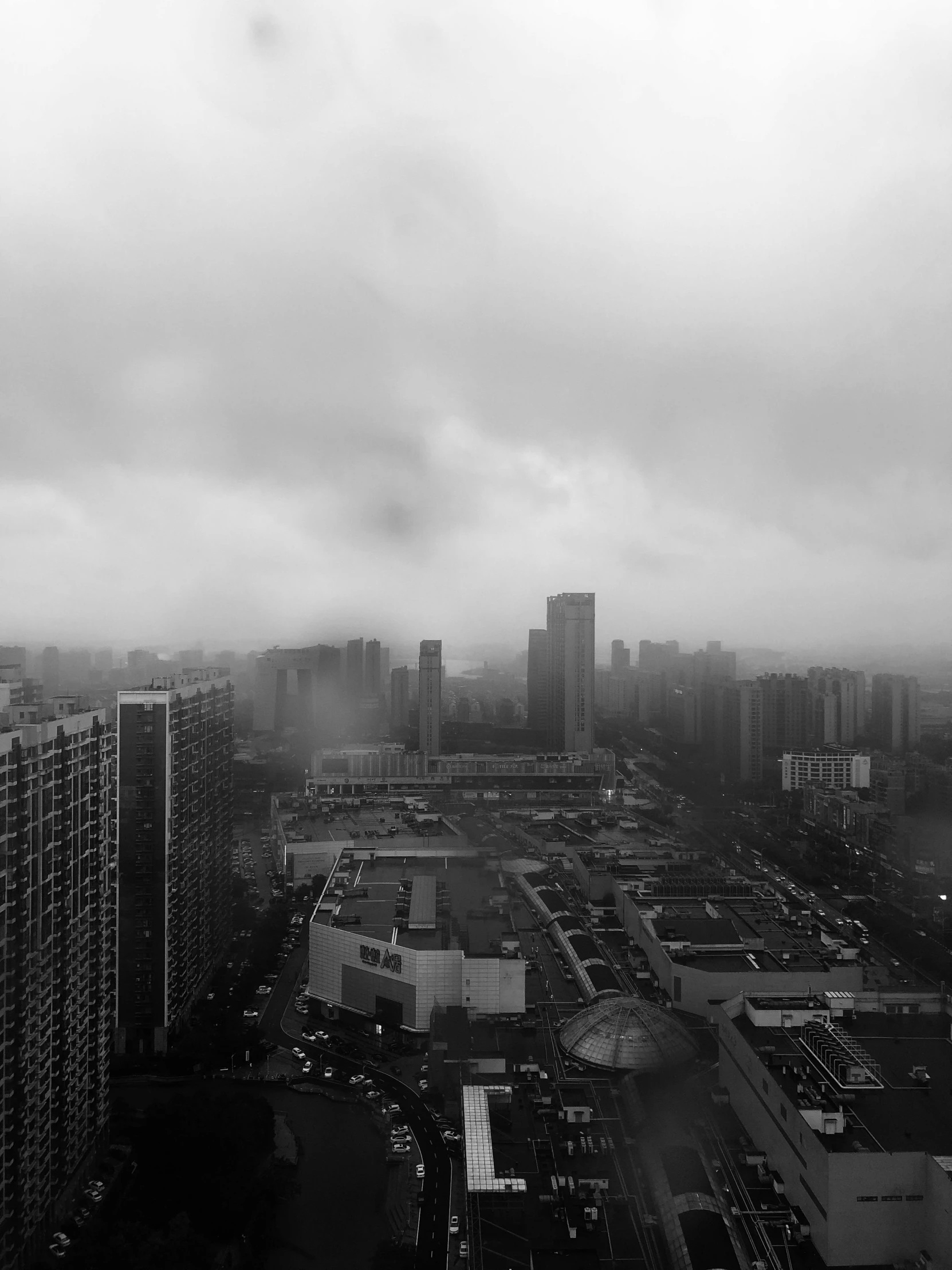 a city with a lot of tall buildings with cloudy skies