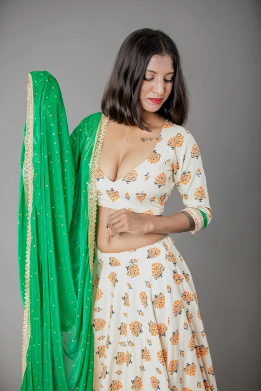 young woman dressed in a white and green outfit and a long green shawl