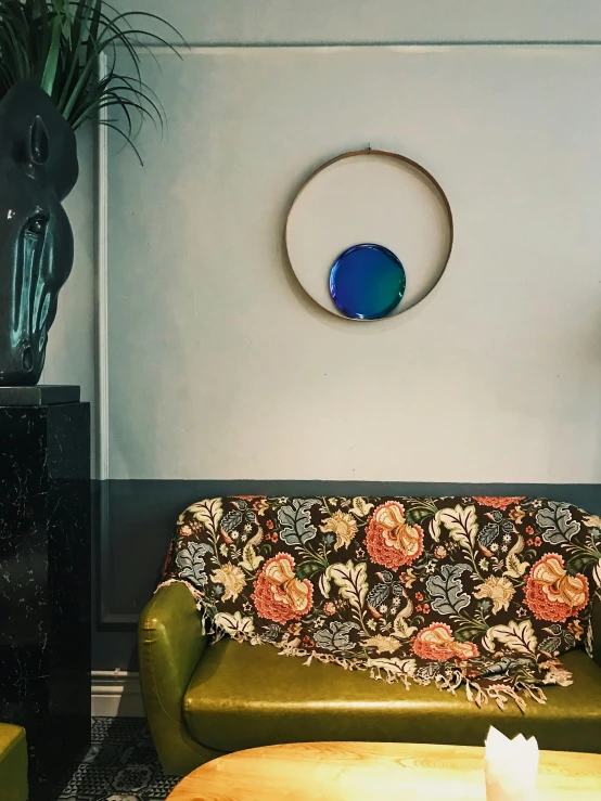 a living room with a couch and round artwork