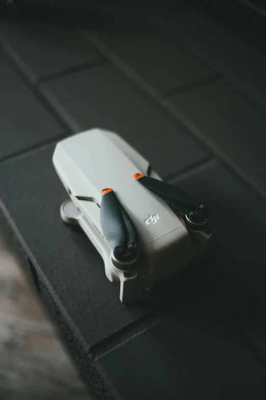 a pair of black scissors resting on top of a piece of grey fabric