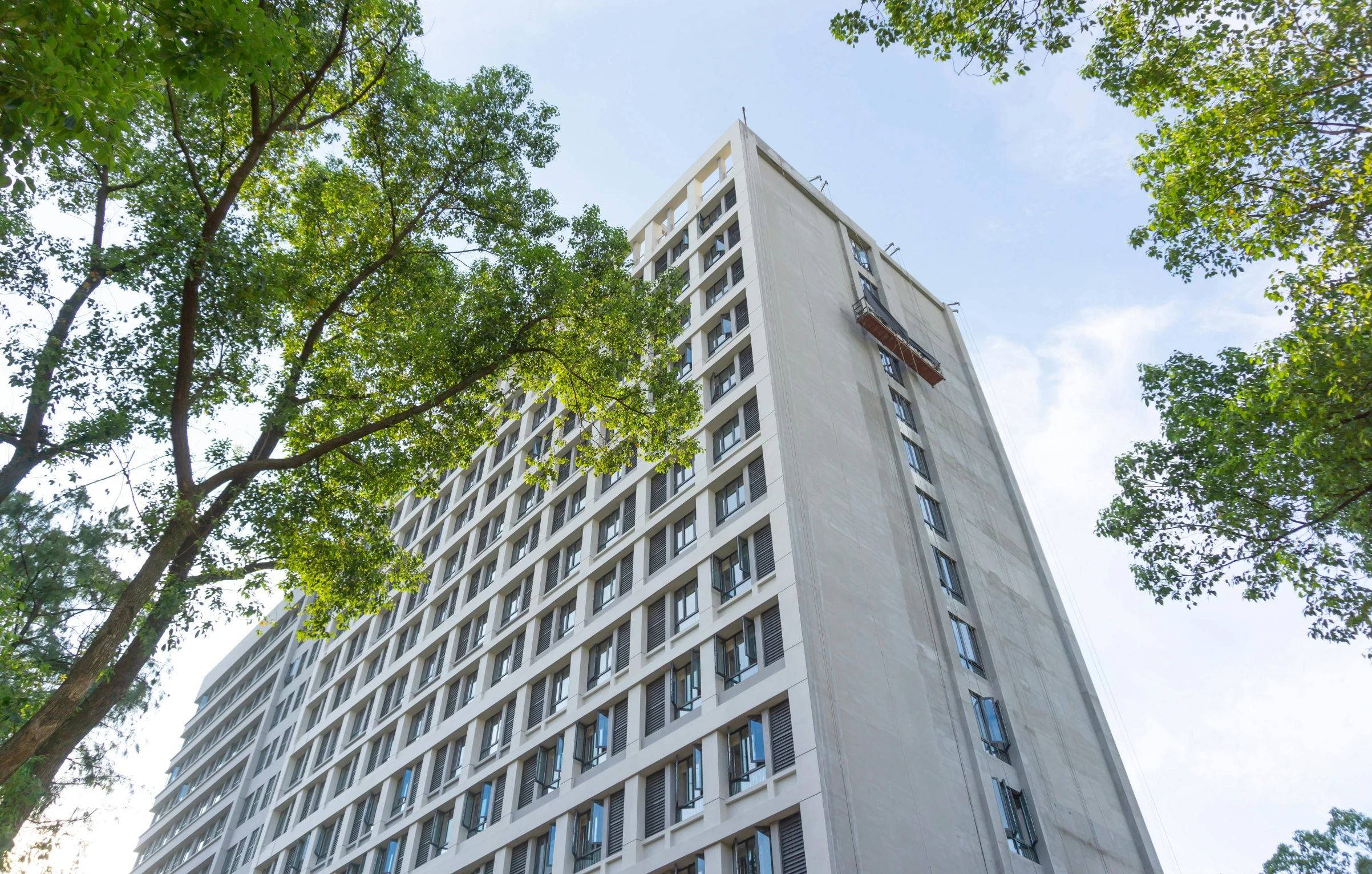 a tall building with a clock and a sky background