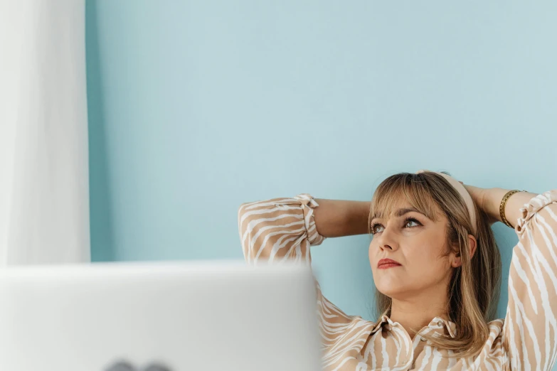 a woman in striped shirt sitting at computer