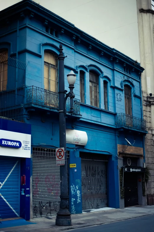 a building that has a light pole and a street lamp in front of it