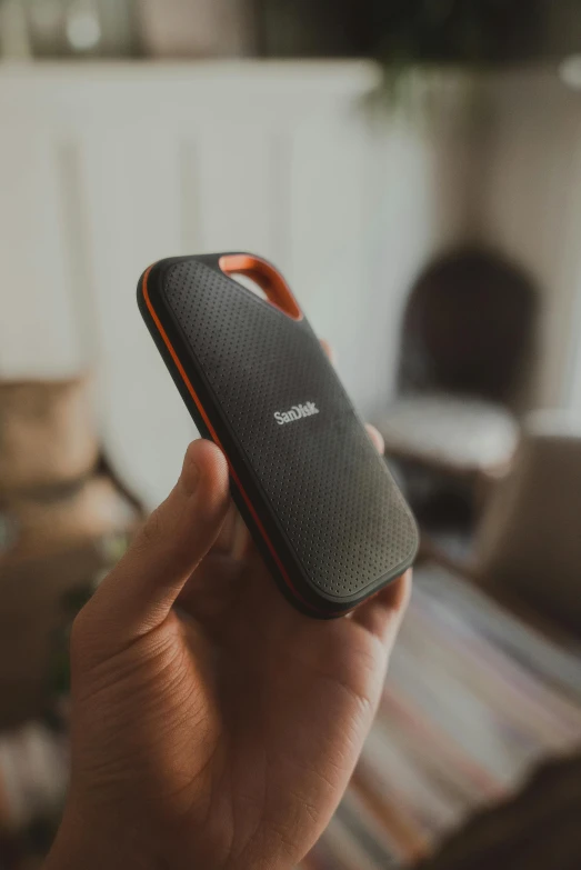 a hand holding a mobile device on a table