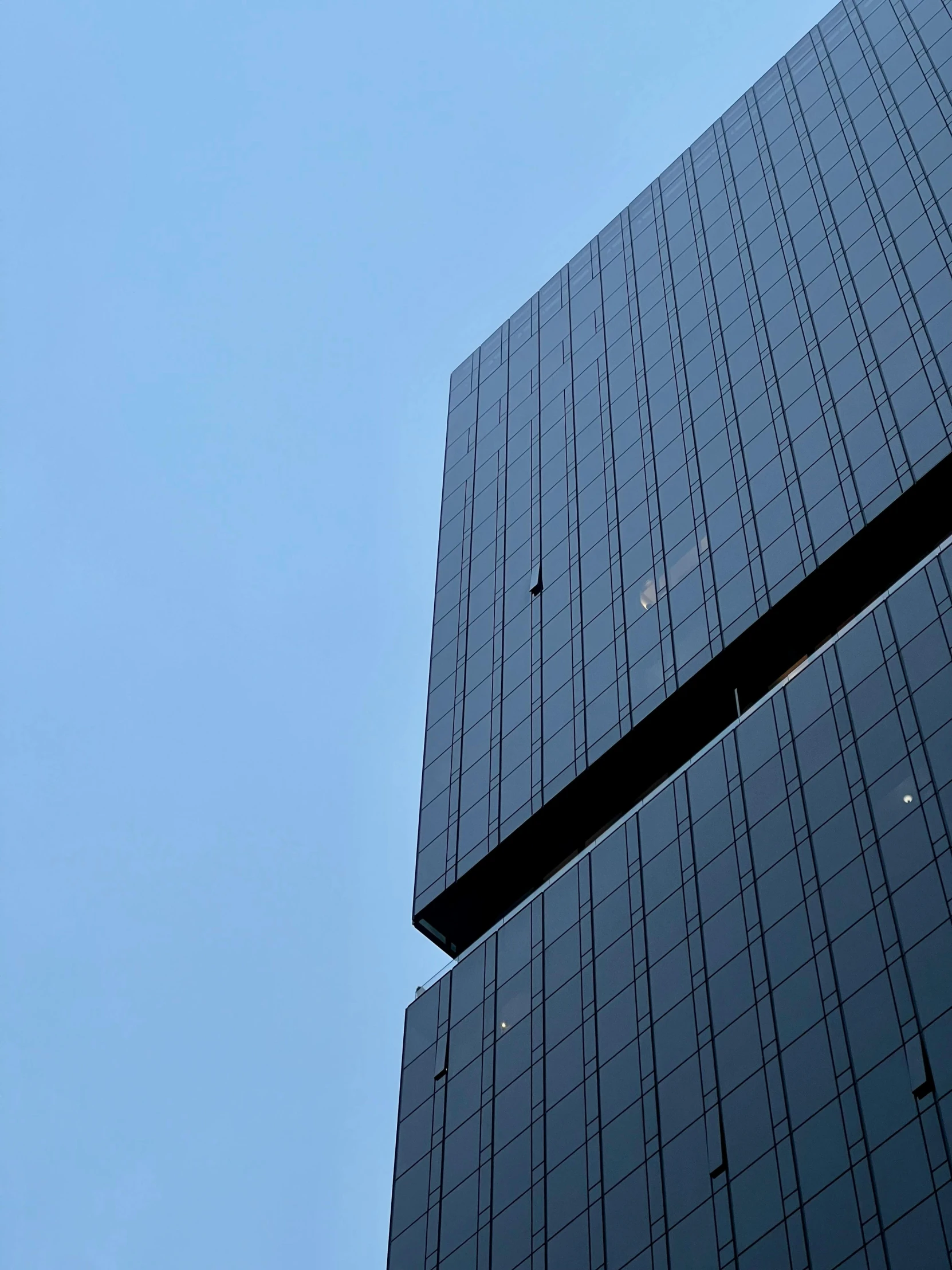 a jet flying through the air near some tall buildings