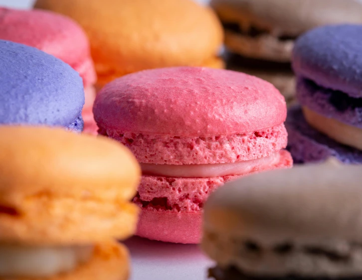 there are different colored macaroons on the table