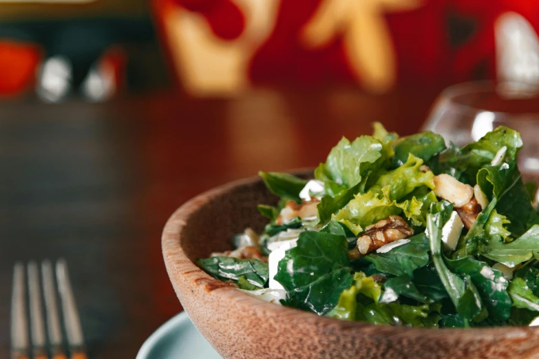 a plate with salad is sitting on the table