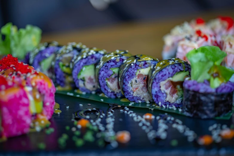 there are colorful sushi rolls laid out on the table