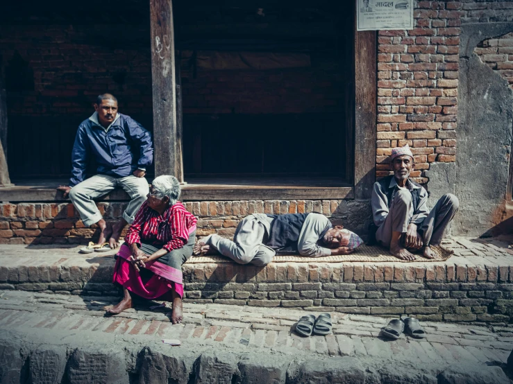 a group of people that are sitting on a street