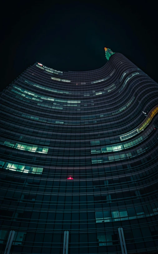 a large building with a kite on top at night